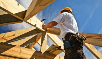 New home construction carpenter working on structure