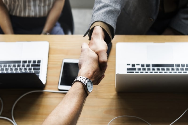 Agreement of buyers and their real estate agent, handshake seals the deal