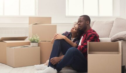 Relocation is a big job, couple taking a break from packing boxes.