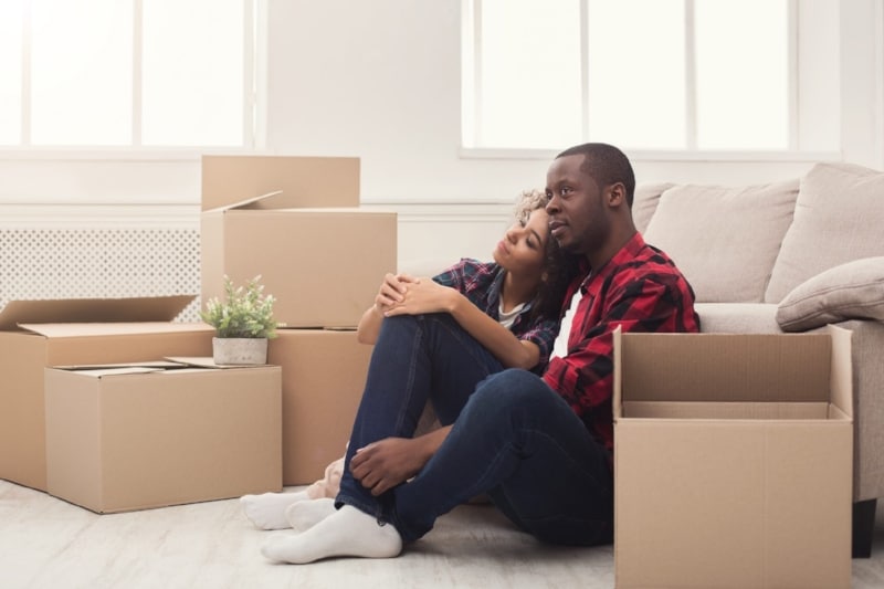 Relocation is a big job, couple taking a break from packing boxes.