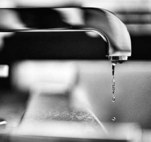 water faucet dripping into sink