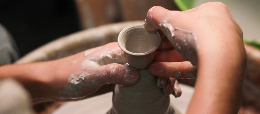 Potter's wheel, hands working with clay