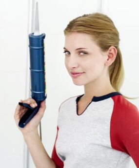 Woman holding a caulk gun