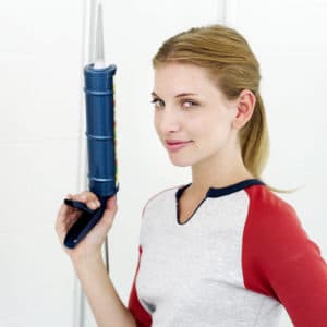 Woman holding a caulk gun
