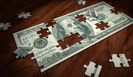 Money puzzle with pieces missing from dollar bill