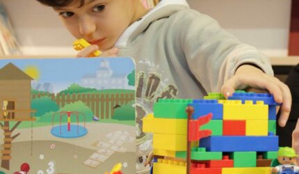 Kid playing with toys in messy kids room