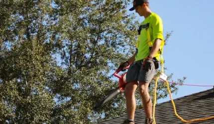 roofer cleaning the roof de-winterize for spring